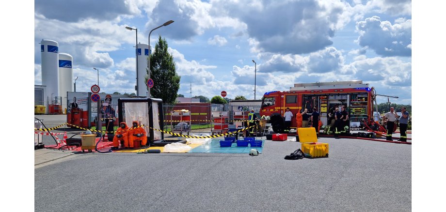 Feuerwehrkräfte beim Einsatz mit einem Gefahrstoffbehälter im Gewerbegebiet Kohlscheid